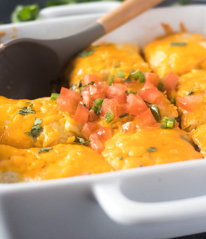 Taco Casserole topped with cheese, chopped tomatoes, jalapeno, and cilantro.