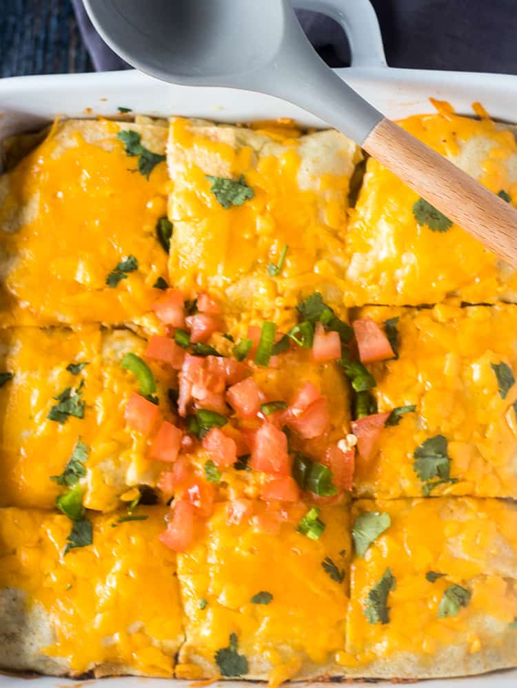 Taco Casserole topped with cheese, diced tomatoes, jalapeno, & cilantro.