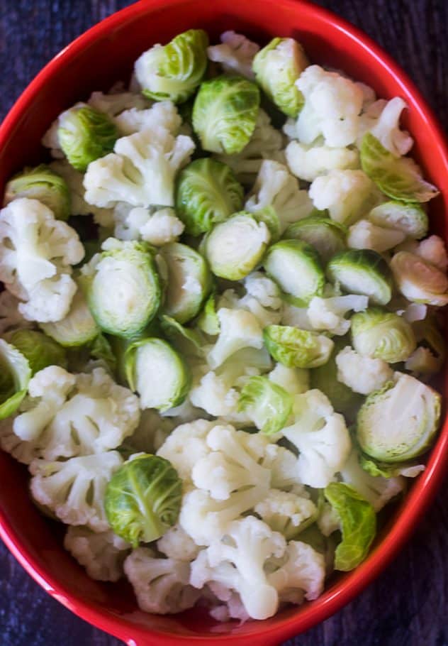 Cauliflower Au Gratin with brussels sprouts in a casserole dish.