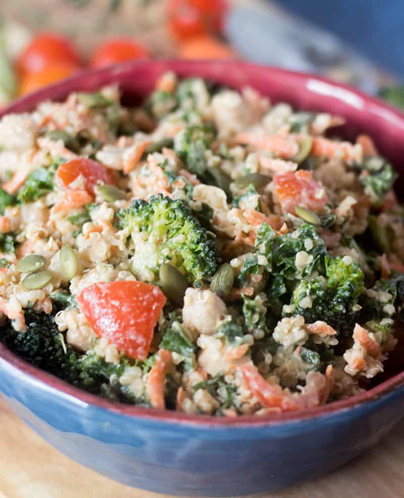 kale, quinoa, broccoli, carrots, grape tomatoes, chickpeas in all bowl tossed with tahini dressing