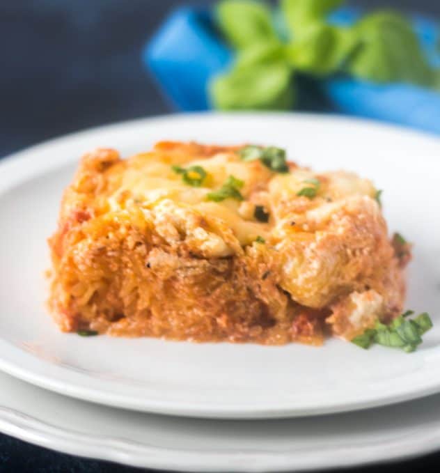spaghetti squash lasagna on a plated topped with fresh basil