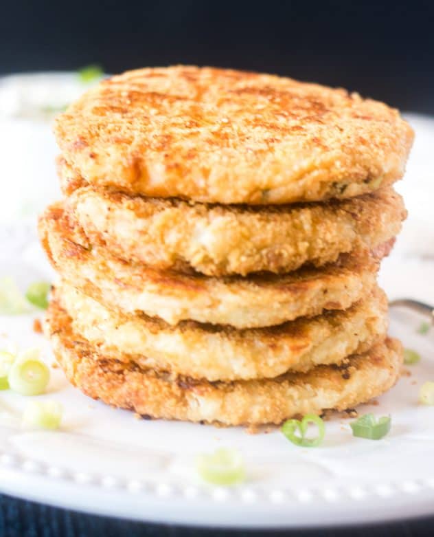 Mashed potato cakes stacked on a plate