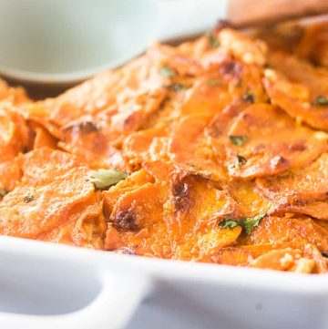 Spicy Scalloped Sweet Potatoes in a white casserole dish.