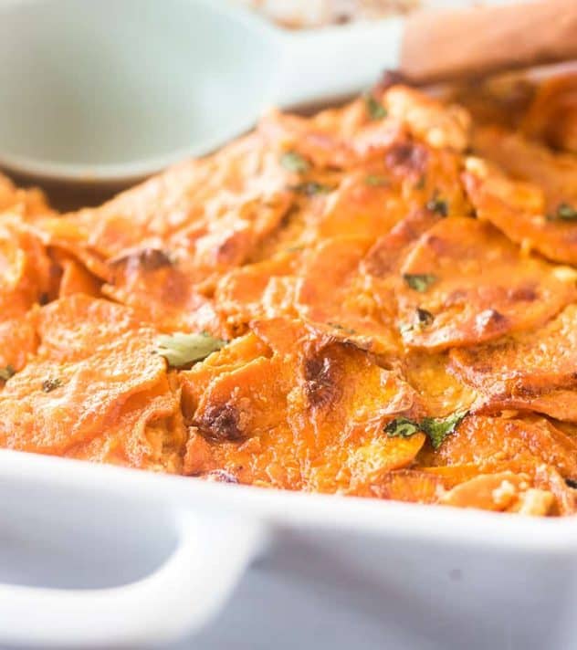 Spicy Scalloped Sweet Potatoes in a white casserole dish.