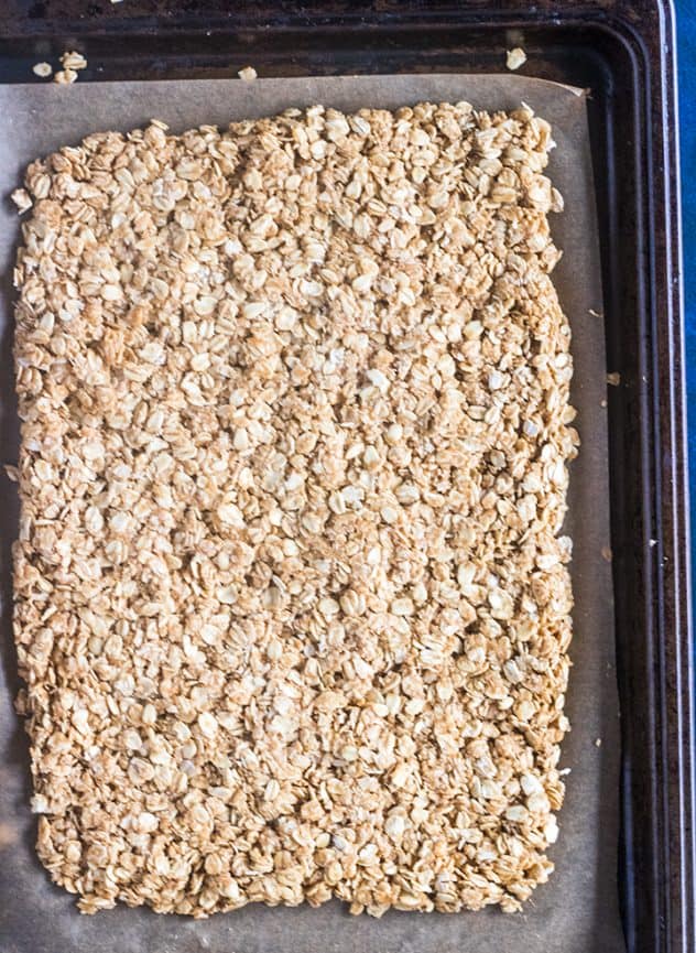 Peanut butter granola pressed into baking pan.