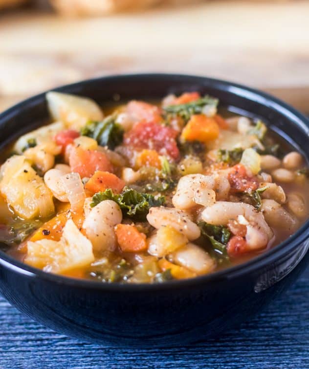 Bean Stew with Kale and white beans in a black bowl.