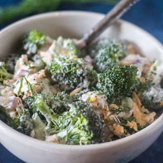 Broccoli Salad in a bowl with a silver serving spoon