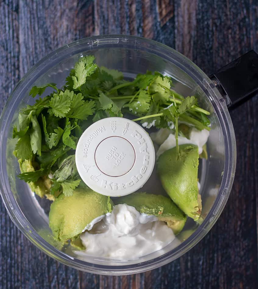 Avocado, greek yogurt, garlic, cilantro in food processor.