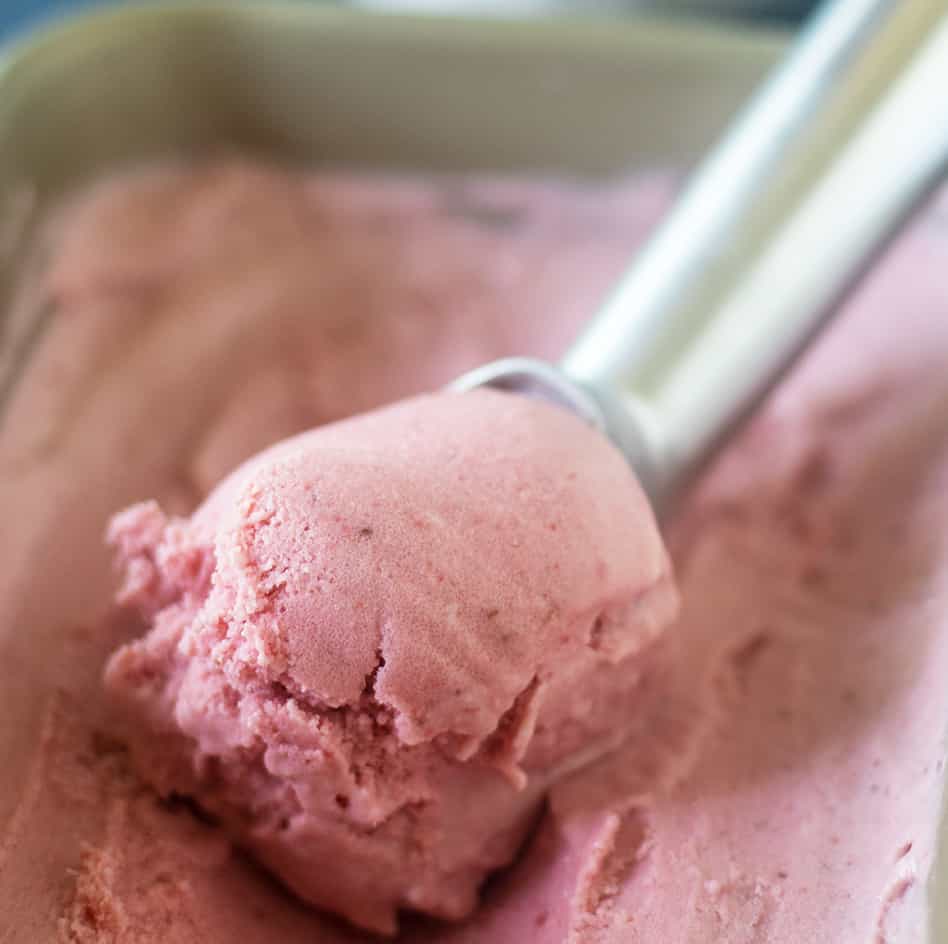 Paleo Strawberry Ice Cream being scooped out of pan.