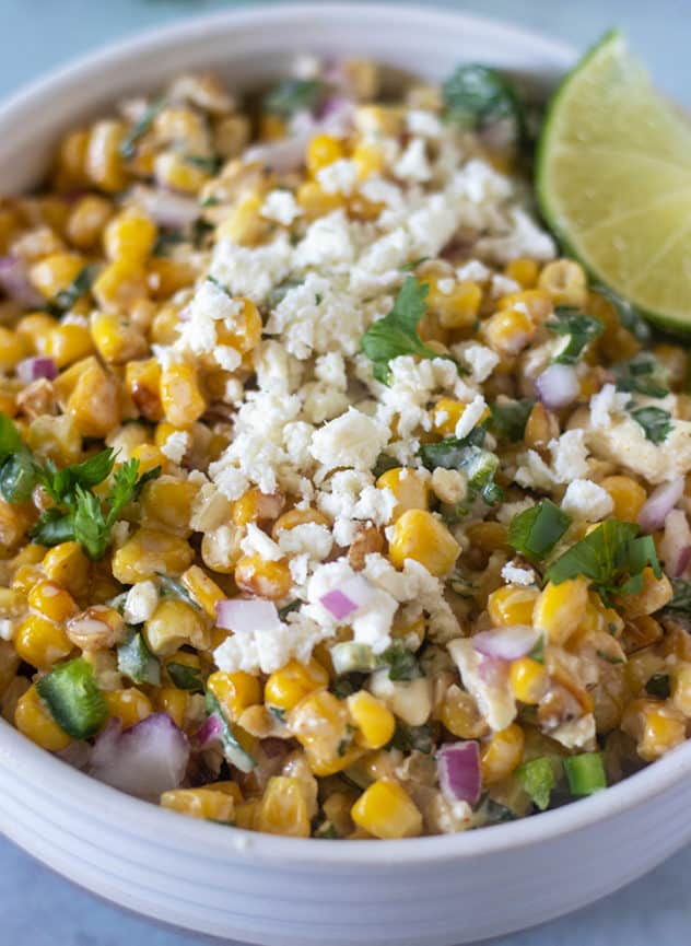 Mexican Street Corn Salad in a bowl topped with feta cheese.
