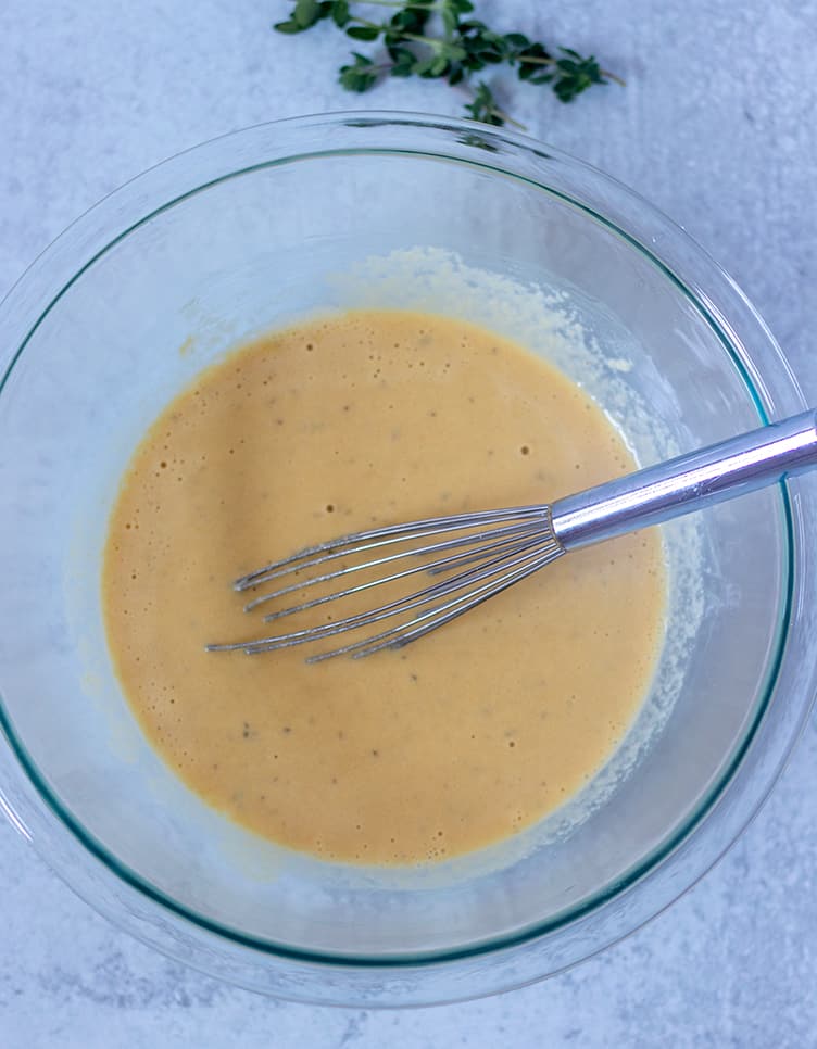 socca ingredients whisked together in glass mixing bowl.