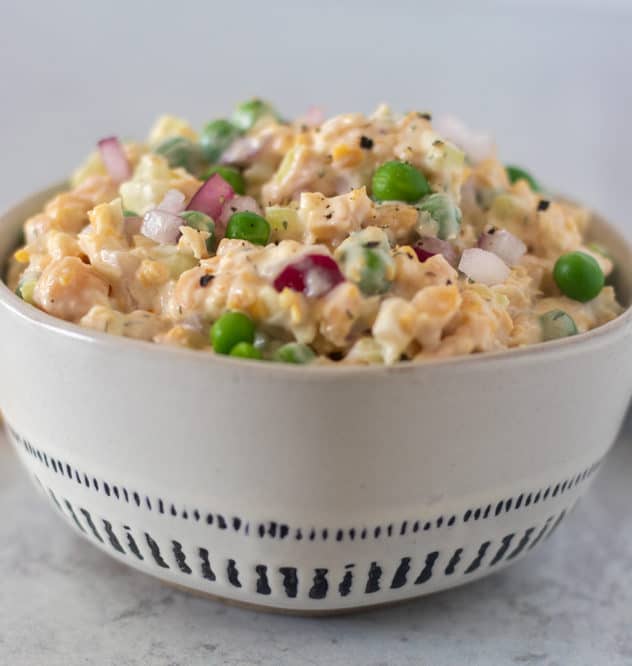 Chickpea salad in white bowl.