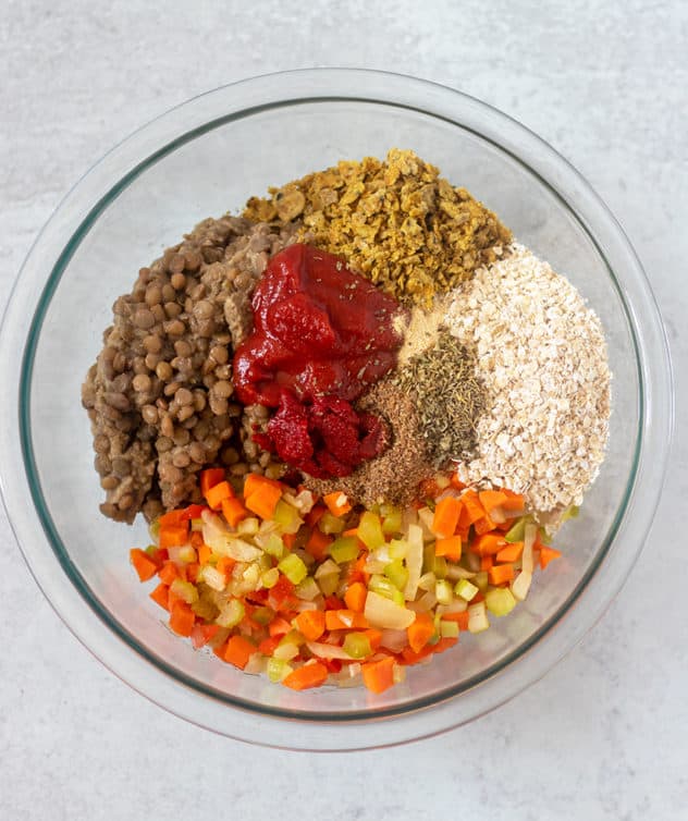 lentils, cooked veggies, oats, cracker crumbs, ketchup, tomato patste and seasonings in a mixing bowl.