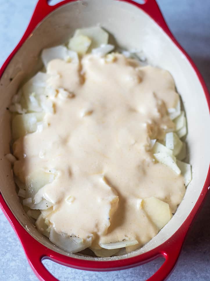 cheesy scalloped potatoes in pan prior to baking.
