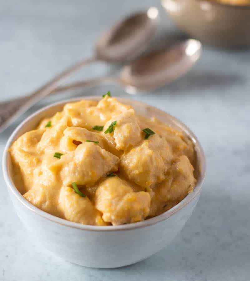 Butternut Squash Mac and cheese in a bowl topped with chives.