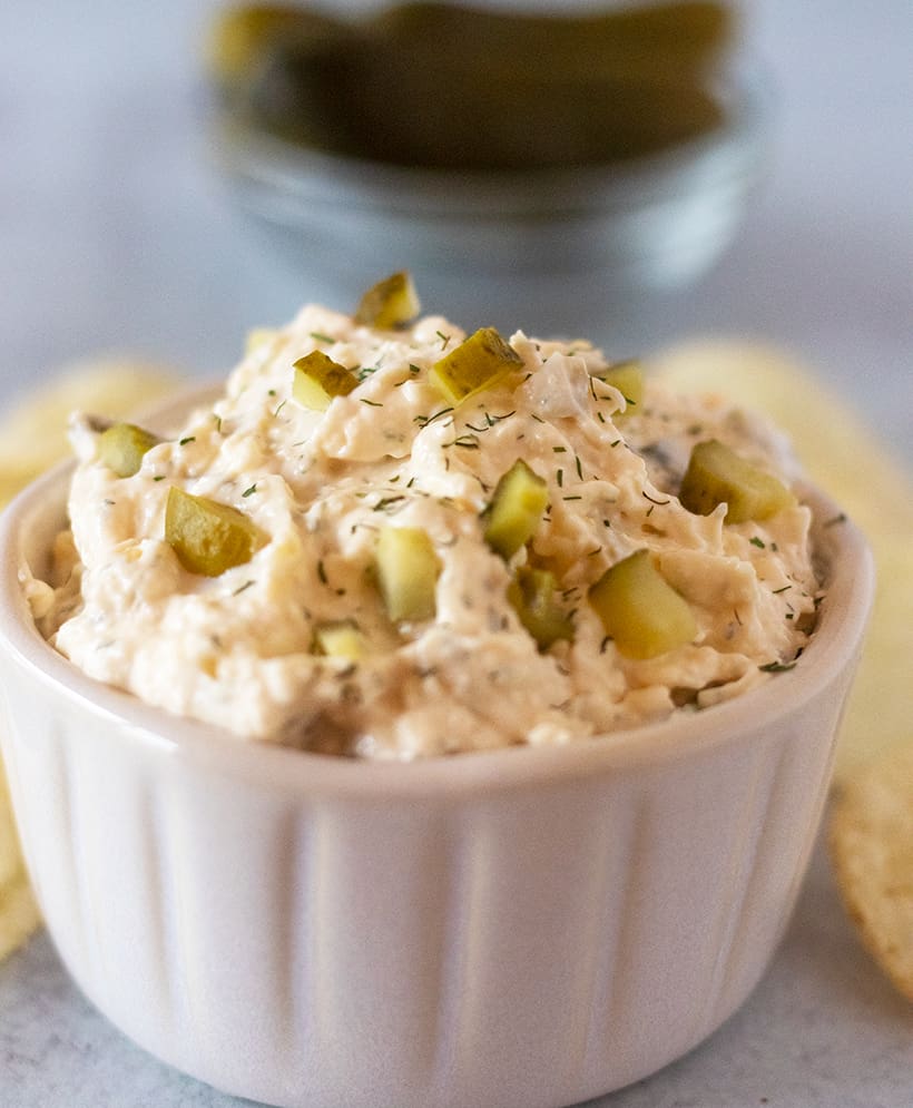 dill pickle dip in a bowl served with chips