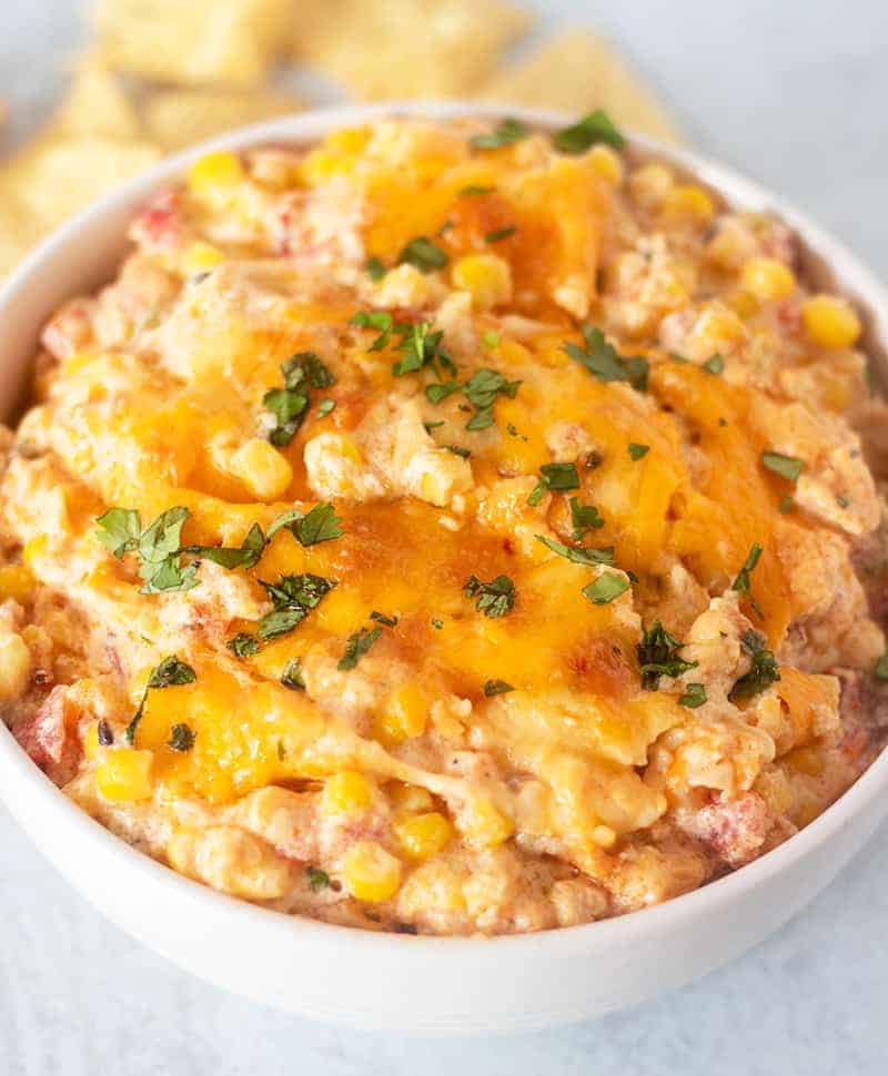 Mexican Corn Dip in a white bowl topped with cilantro.