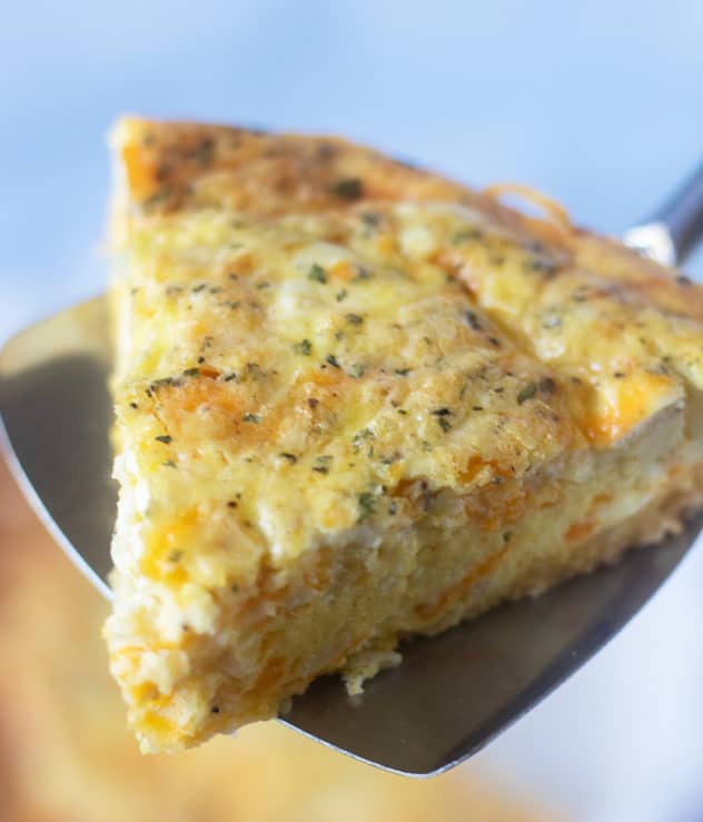 three cheese quiche on a spatula to serve