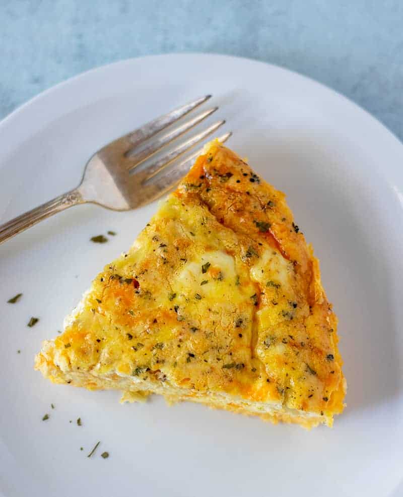 Three Cheese Quiche on a white plate.