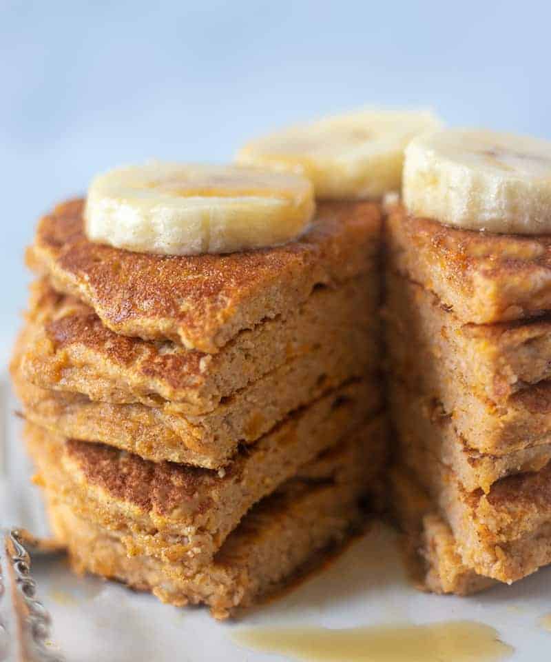 sweet potato pancakes topped with banana and maple syrup
