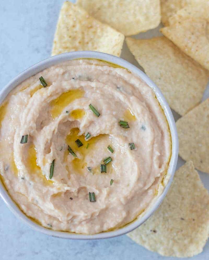 White Bean dip garnished with fresh rosemary and olive oil