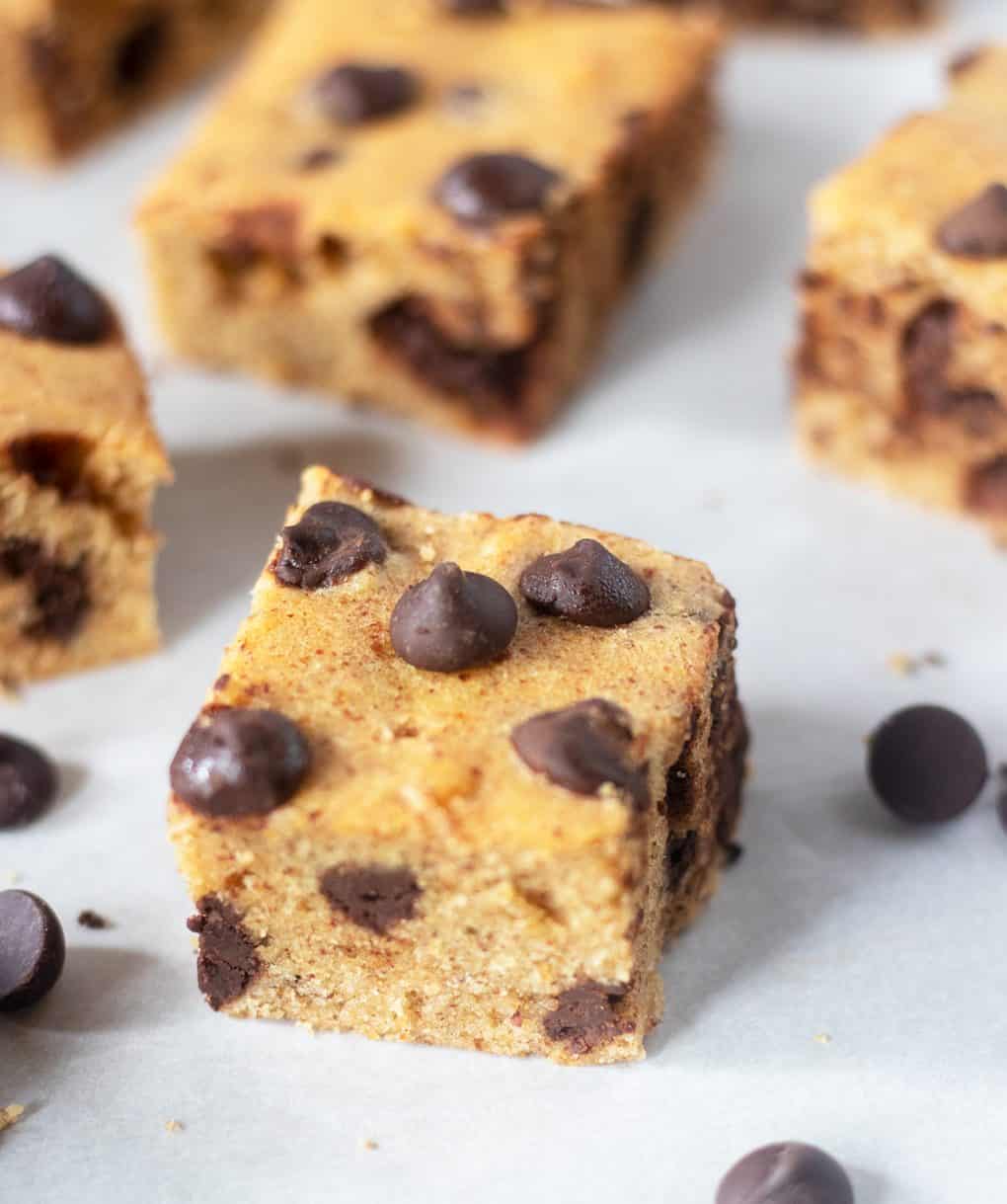 Chocolate Chip Cookie Bars baked and cut on parchment paper