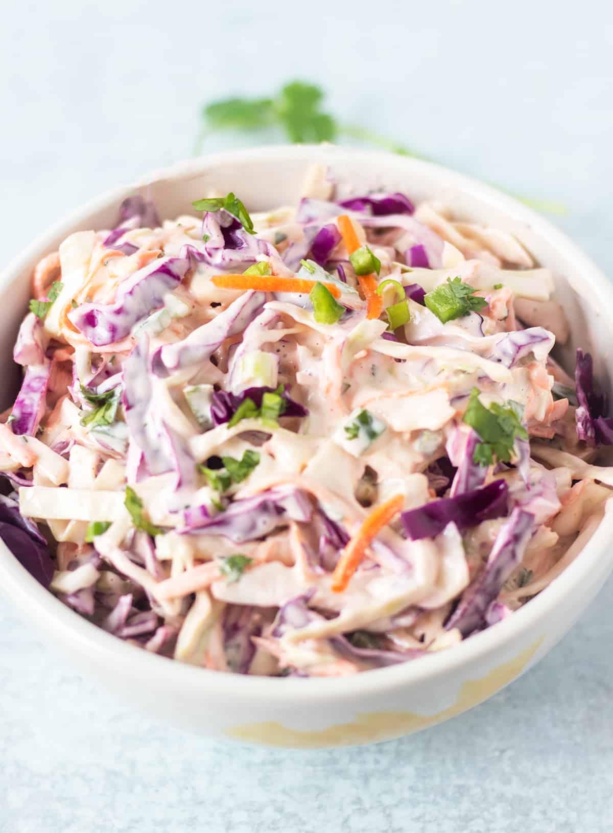 Cilantro lime slaw in a white serving bowl