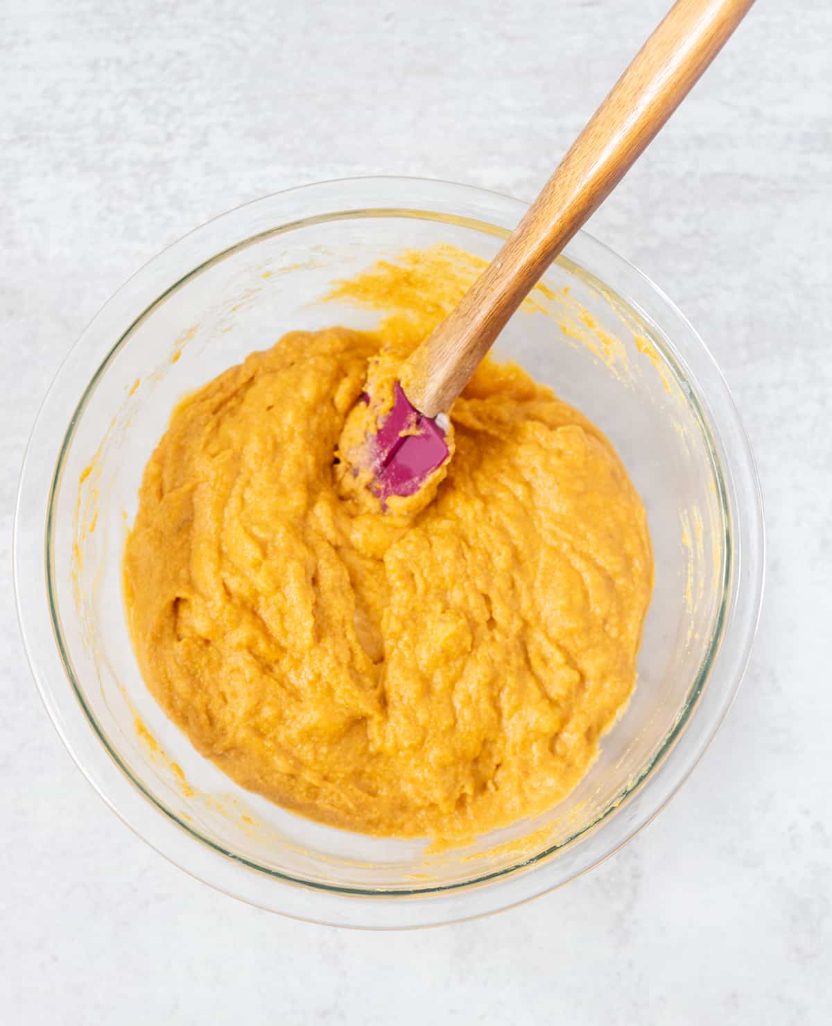 batter for muffins in a clear glass mixing bowl