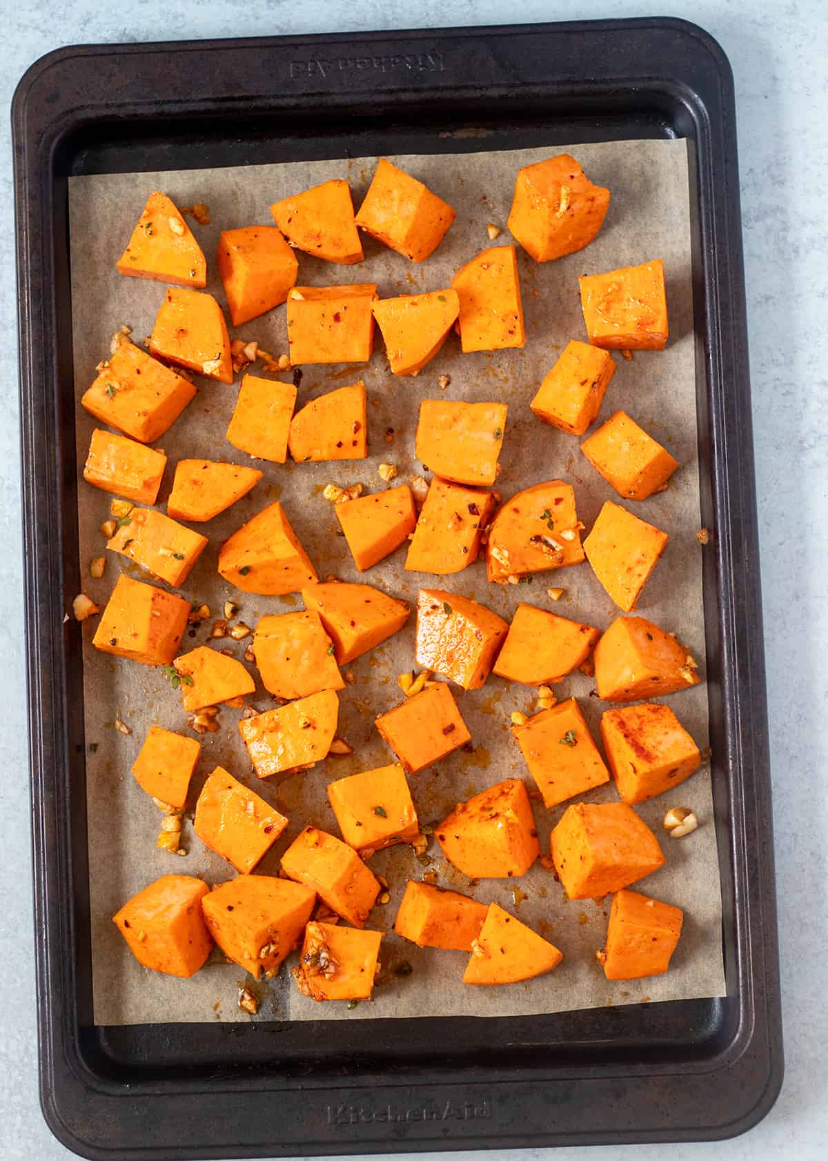 cube roasted sweet potatoes on baking sheet prior to being baked