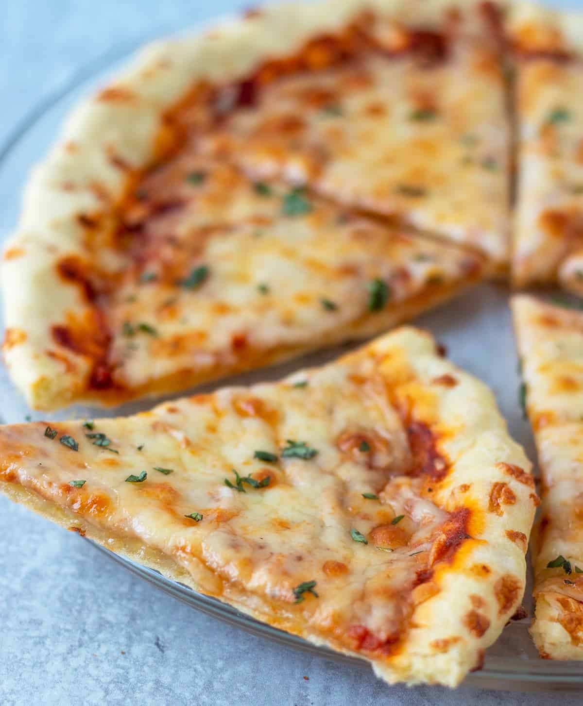 pizza after being topped and cooked on a serving plate