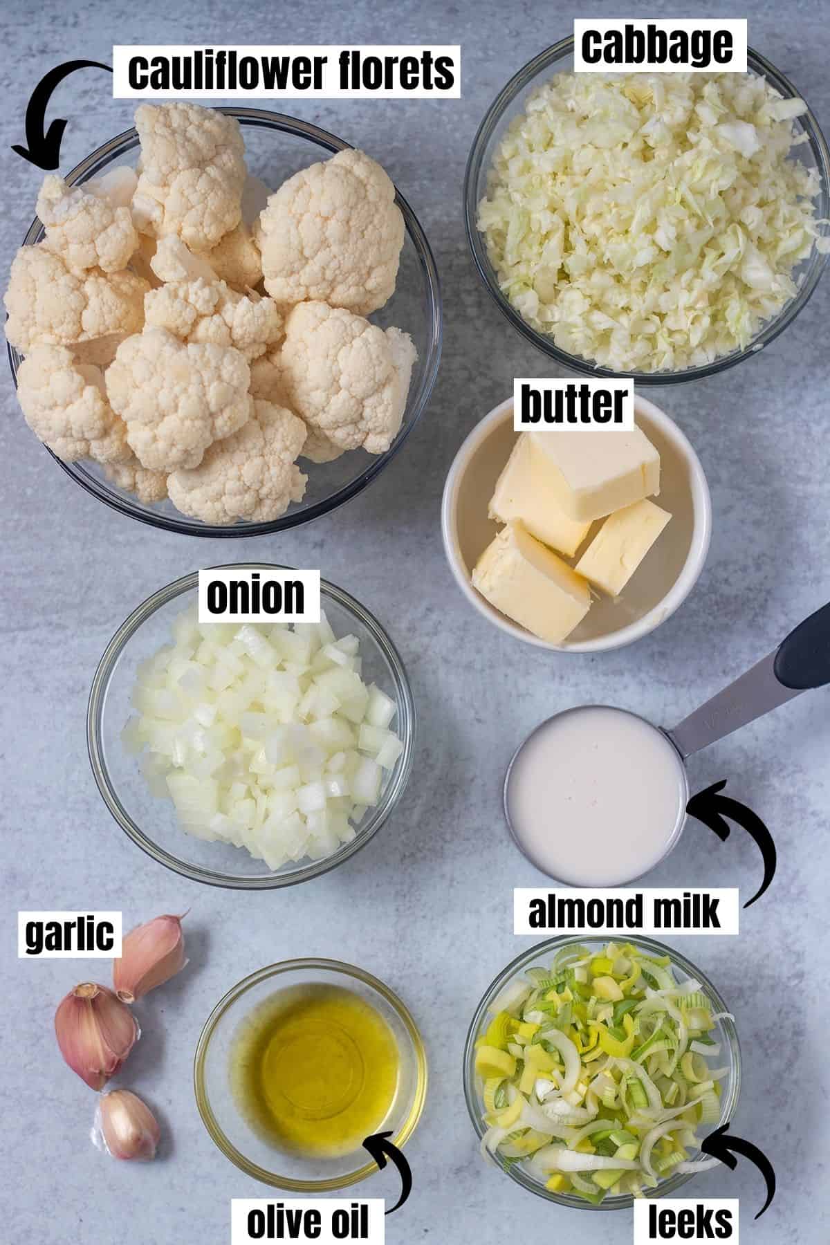 cauliflower florets, chopped cabbage, chopped onion, butter, almond milk, garlic, olive oil, chopped leeks