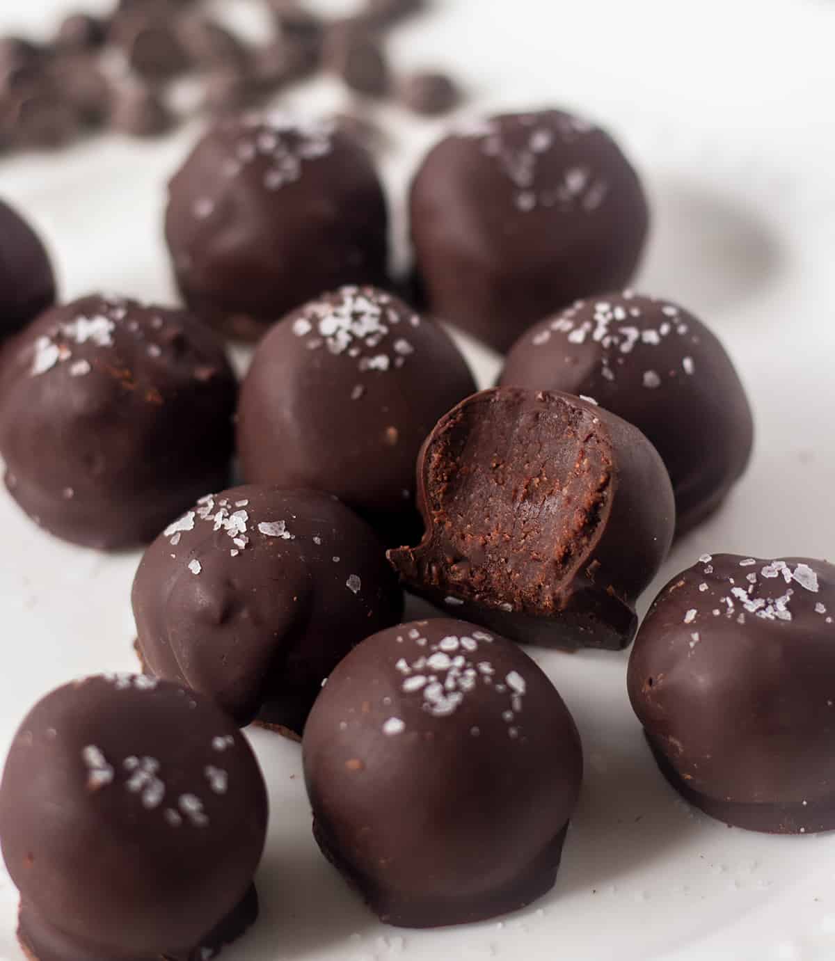 truffles on white plate with one of the truffles biten