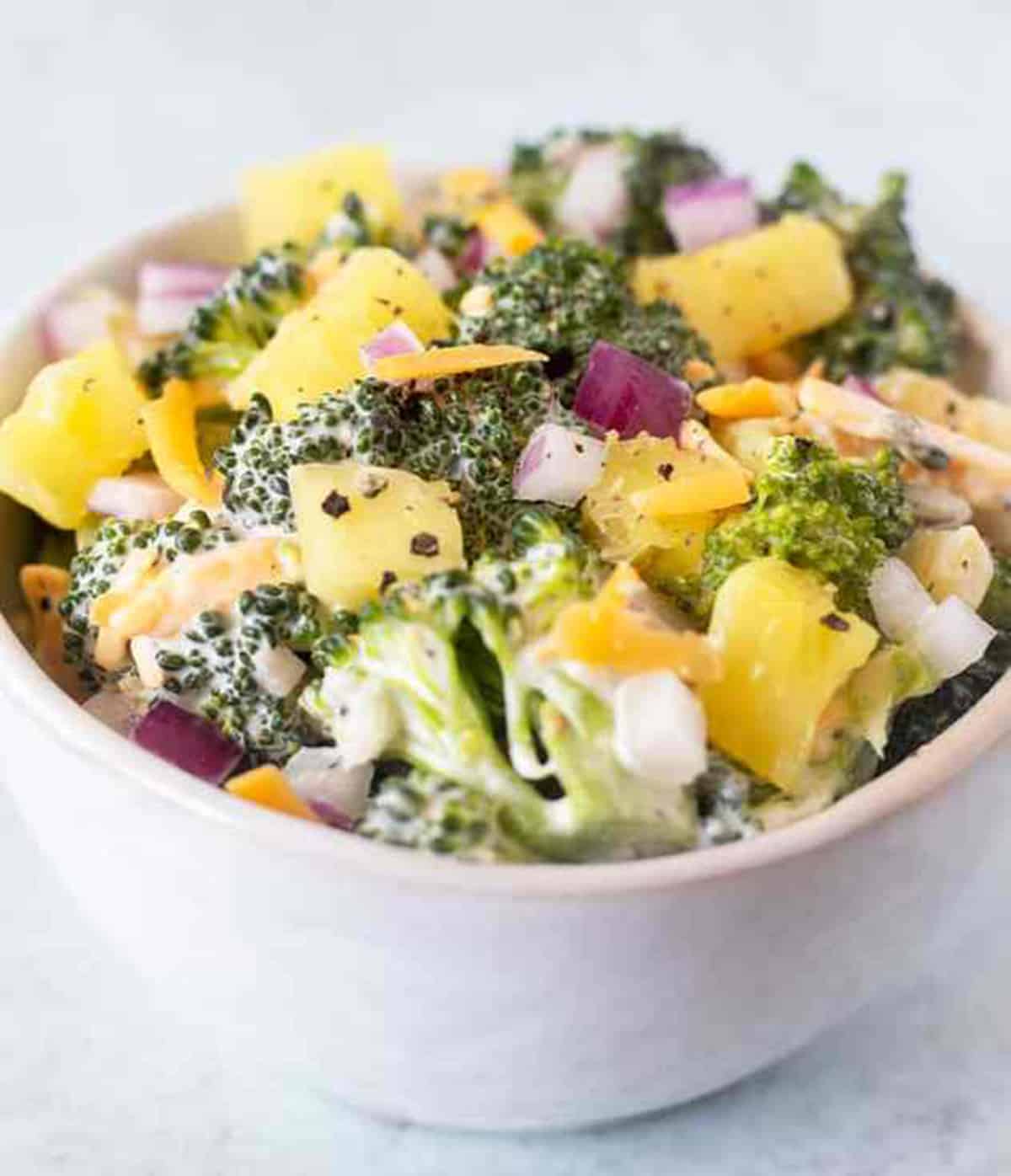 broccoli pineapple salad in a white bowl