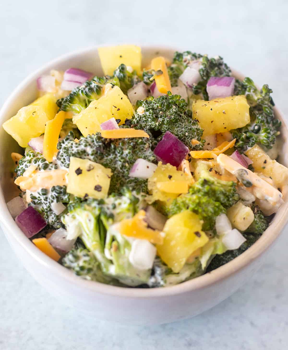 broccoli pineapple salad in a white bowl