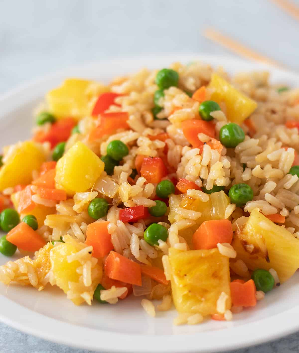 pineapple fried rice on a white plate