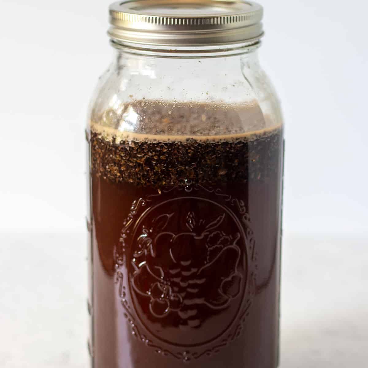 cold brew coffee in mason jar covered with lid to brew in the fridge.