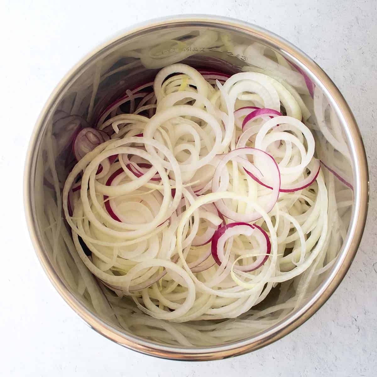thinly sliced yellow and red onions added to pot prior to cooking.