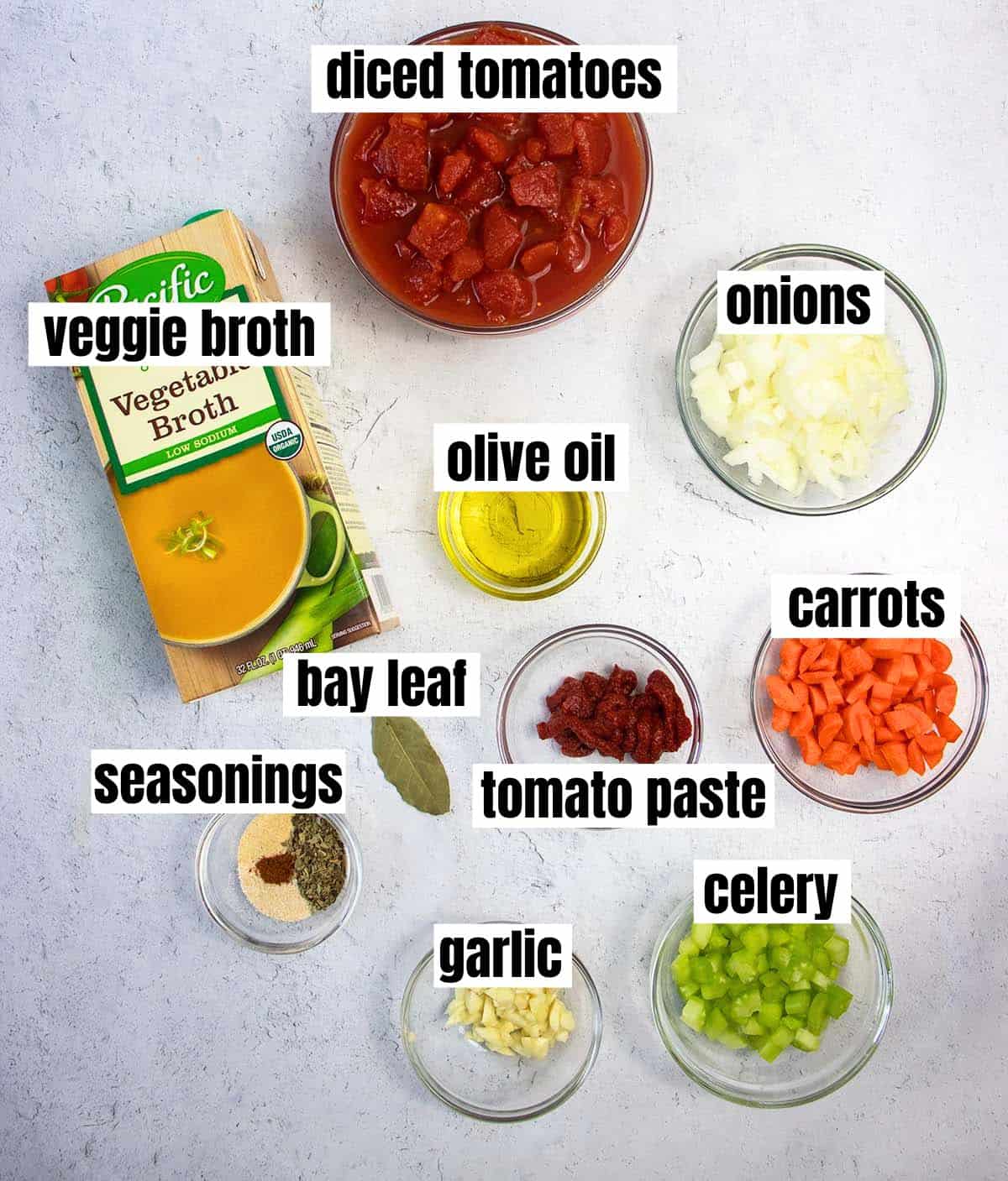 Ingredients in vegan tomato soup which included diced tomatoes, veggie broth, onions, olive oil, carrots, tomato paste, celery, garlic, bay leaf, seasonings.