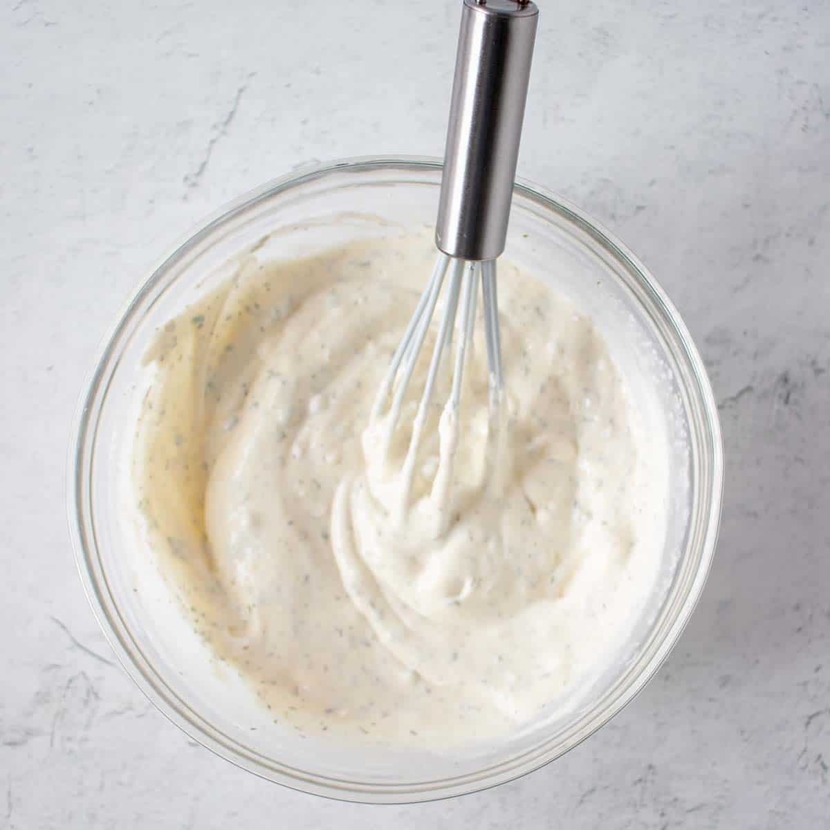 Homemade ranch dip after being mixed together in a small mixing bowl with a whisk.