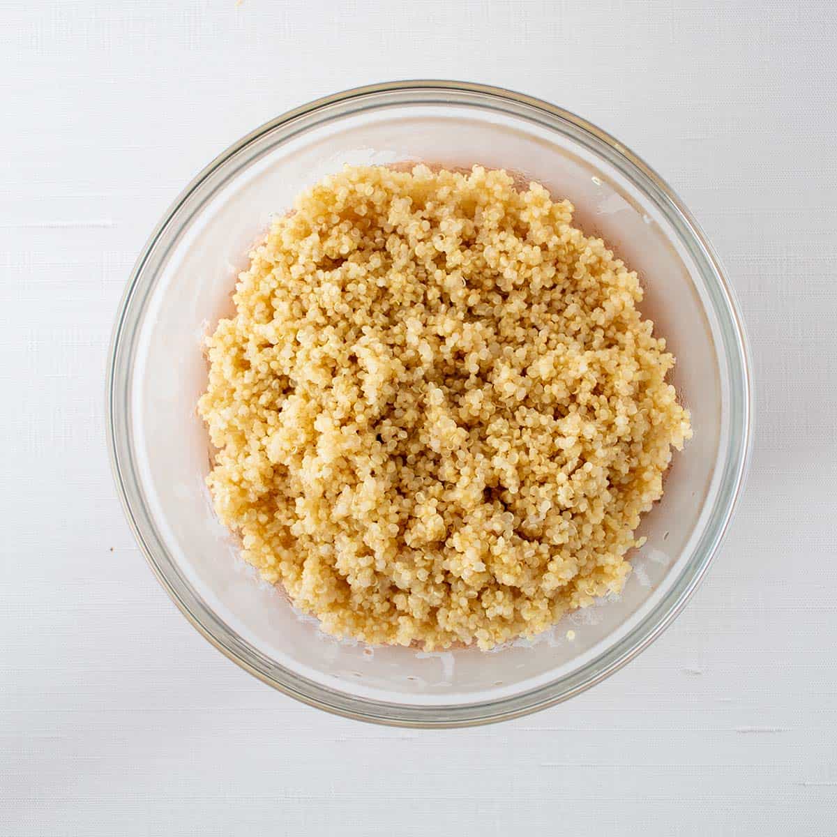 cooked quinoa in a clear glass mixing bowl.