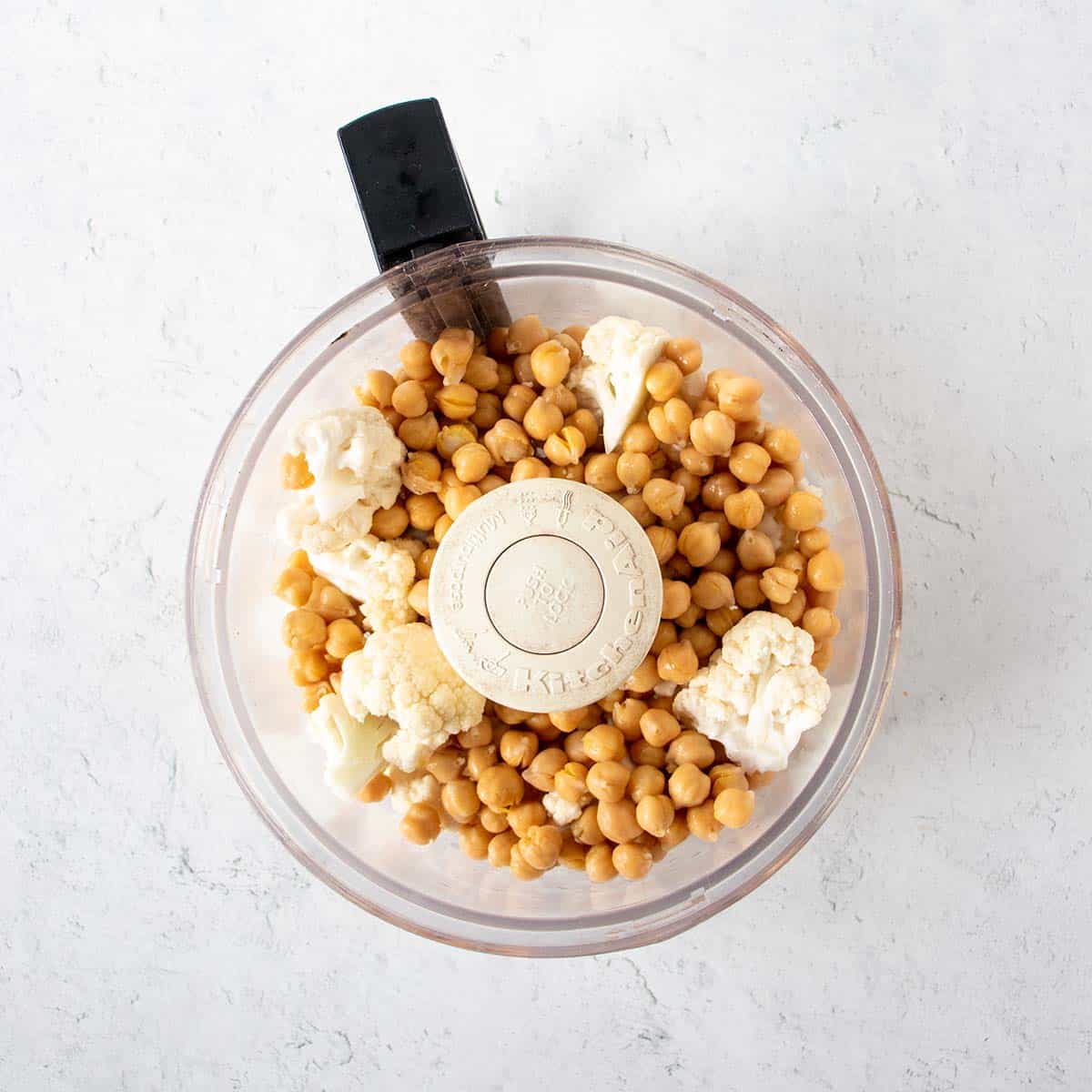 Chickpeas and cauliflower florets added to the food processor.